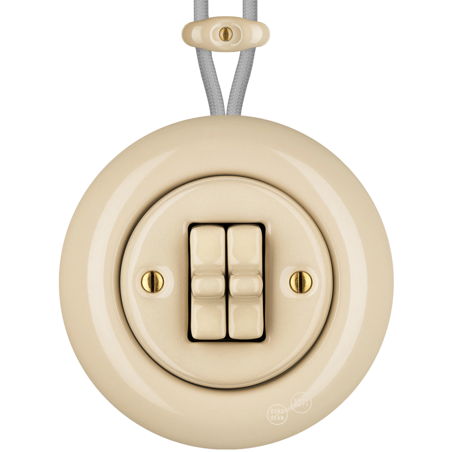 PORCELAIN KATY PATY COLONA ROUND SURFACE MOUNTED DOUBLE TOGGLE BUTTON SWITCH SAND - DYKE & DEAN