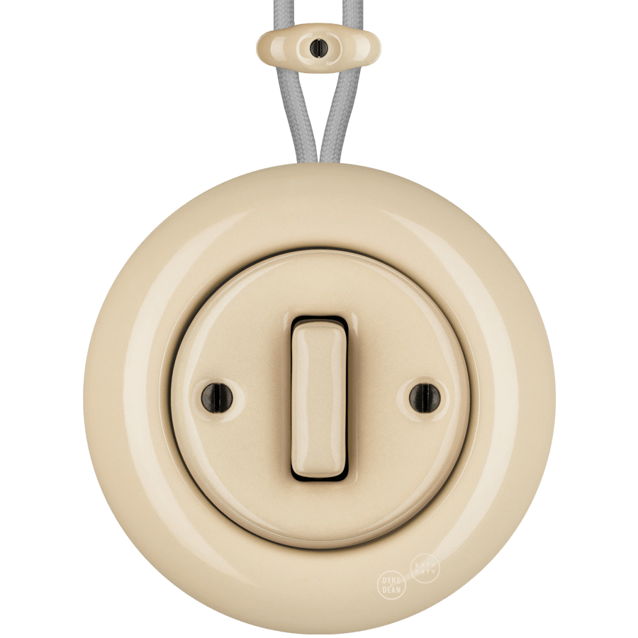 PORCELAIN KATY PATY COLONA ROUND SURFACE MOUNTED SLIM BUTTON SWITCH SAND - DYKE & DEAN