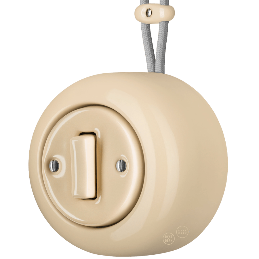 PORCELAIN ROUND SURFACE MOUNTED SLIM BUTTON SWITCH SAND - DYKE & DEAN